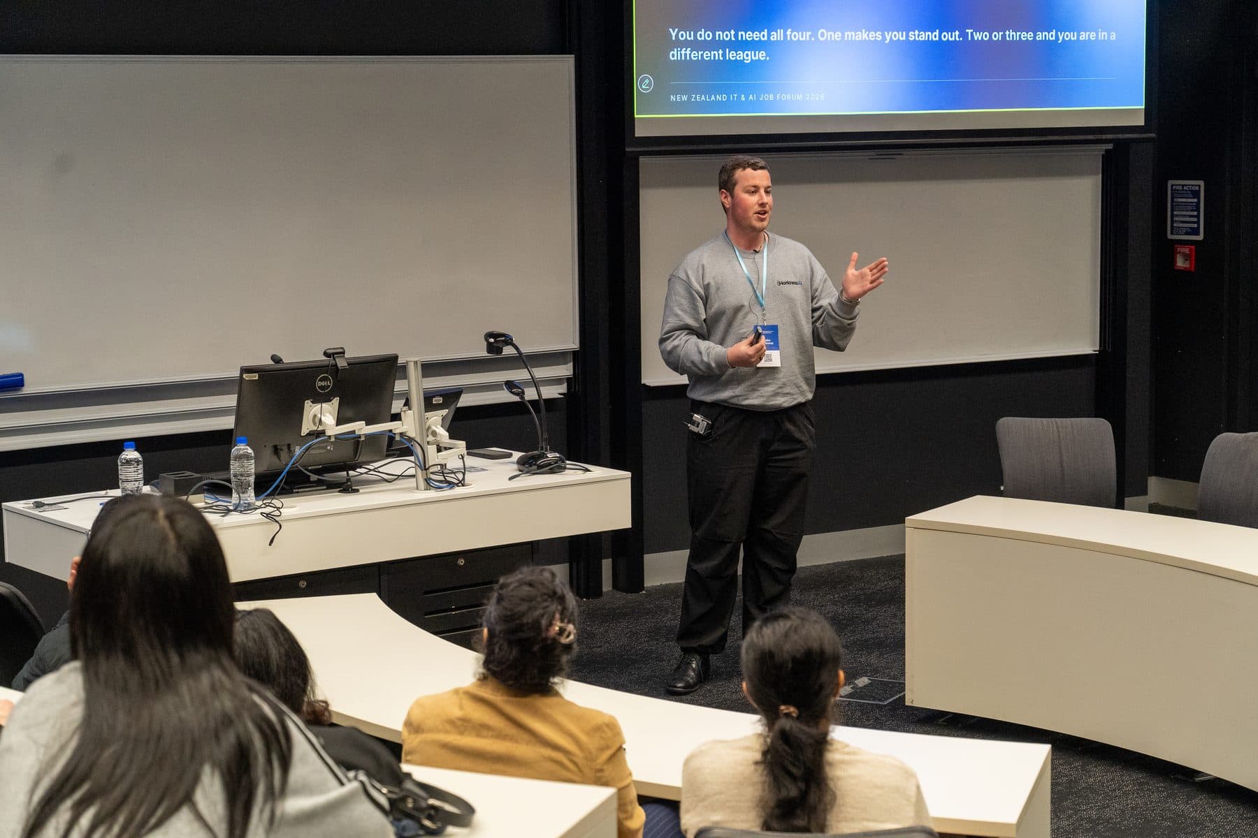 Blake Harkness speaking to students seated in a University of Auckland lecture theatre at the NZ IT and AI Job Forum