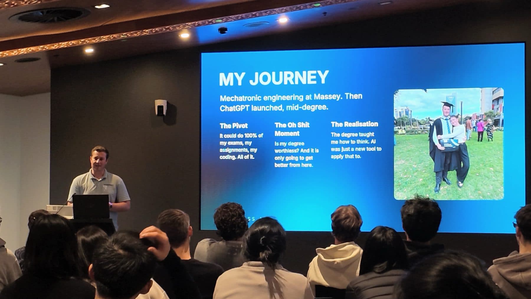 Blake Harkness presenting his "My Journey" slide, about pivoting into AI halfway through a mechatronics degree, to a room of students