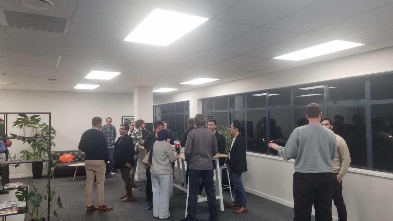 Attendees networking over drinks after the talks at the Young Kiwis in AI Palmerston North meetup