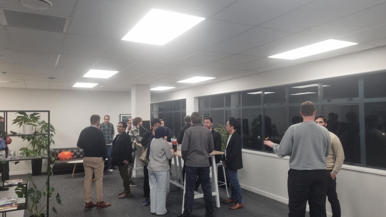 Attendees networking over drinks after the talks at the Young Kiwis in AI Palmerston North meetup
